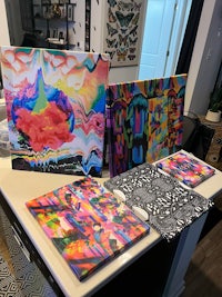 a group of colorful paintings on a table in a kitchen